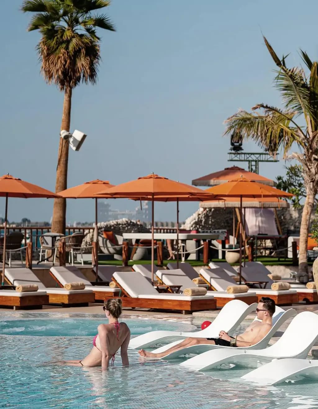 Bla Bla Dubai beach club with pool, umbrellas and lively outdoor restaurant area