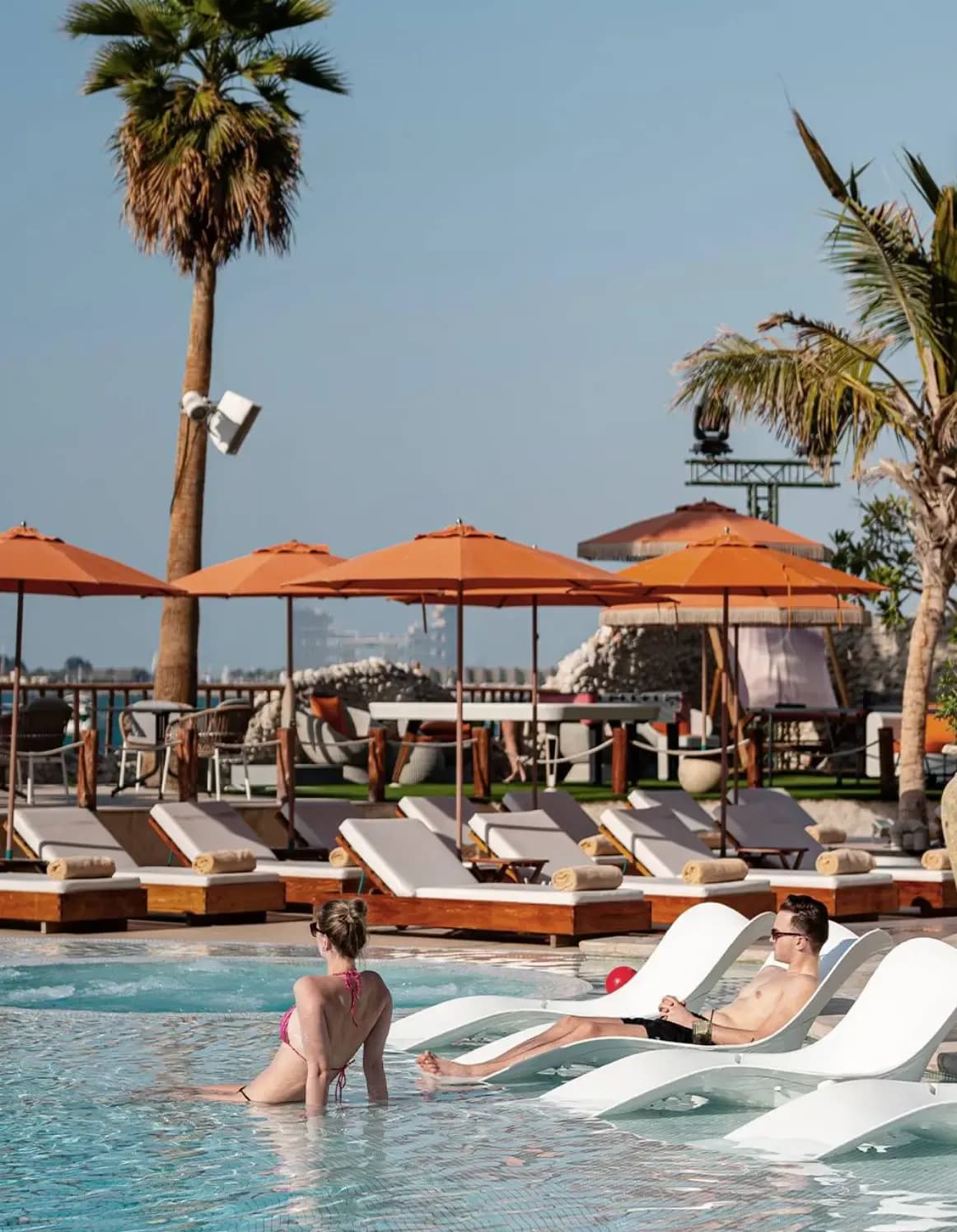 Bla Bla Dubai beach club with pool, umbrellas and lively outdoor restaurant area