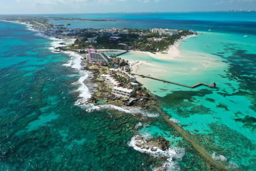 Aerial view of a beach club in Cancun with turquoise water and white sand beach