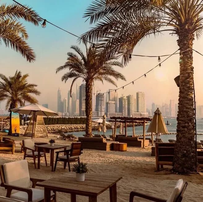 Ula Dubai beach club with boho style decor and palm trees