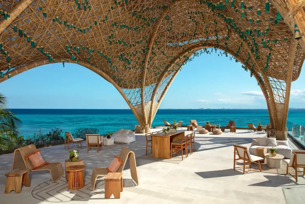 uxury beach club restaurant with wooden architecture and ocean view