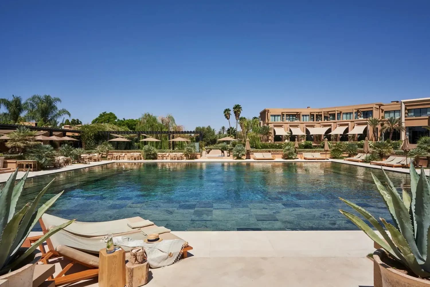 Pool day pass in Marrakech with resort sunbeds, gardens and blue sky