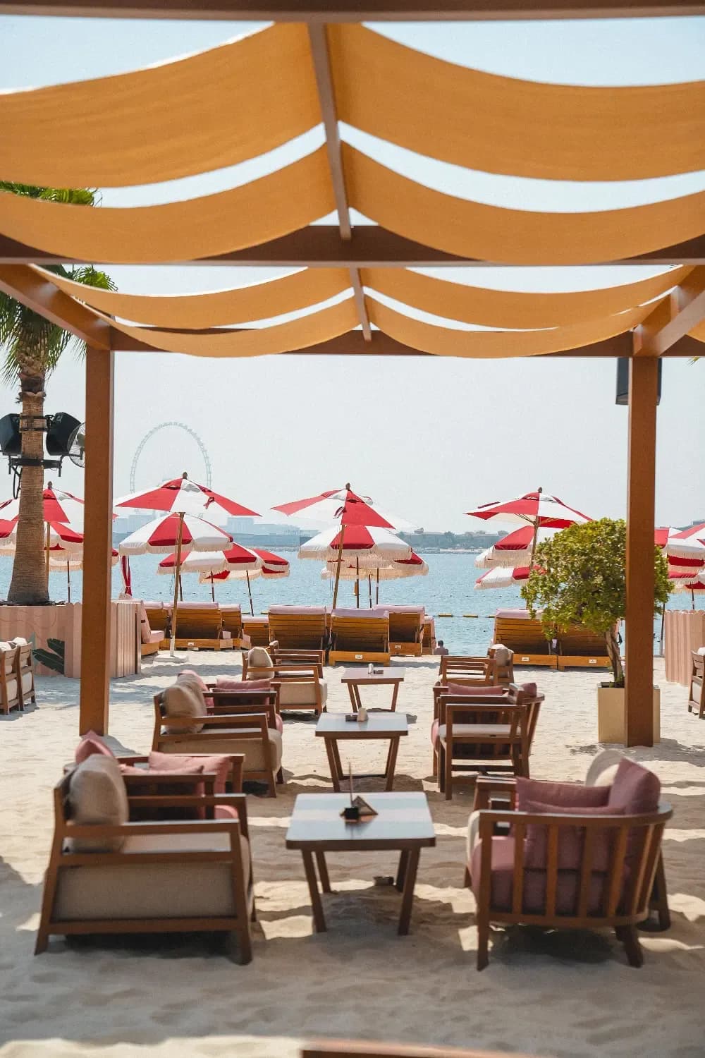 February 30 Dubai beach club with striped umbrellas and colorful sunbeds