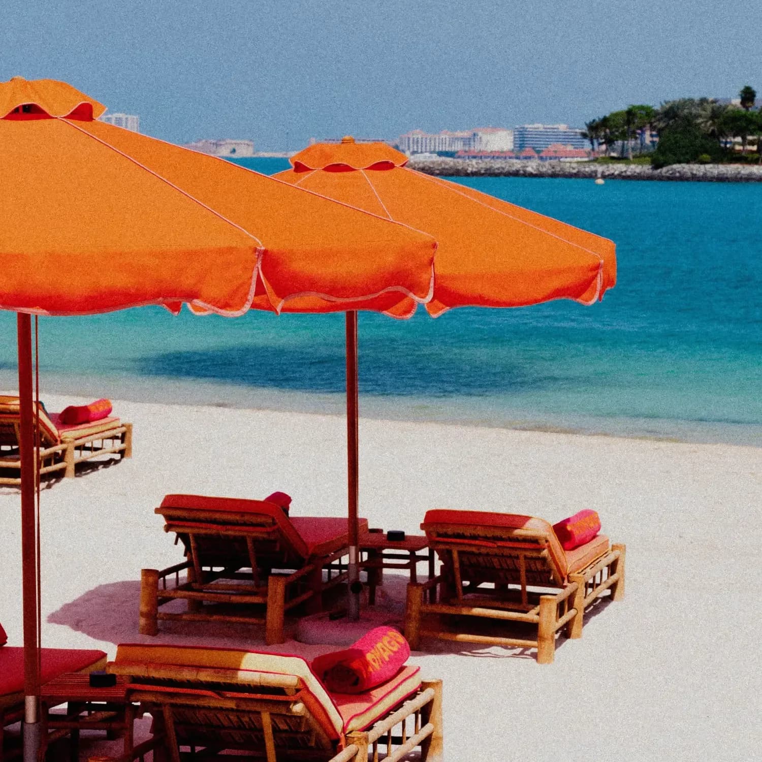 Tagomago Dubai minimalist beach club with orange umbrellas and calm seaside atmosphere